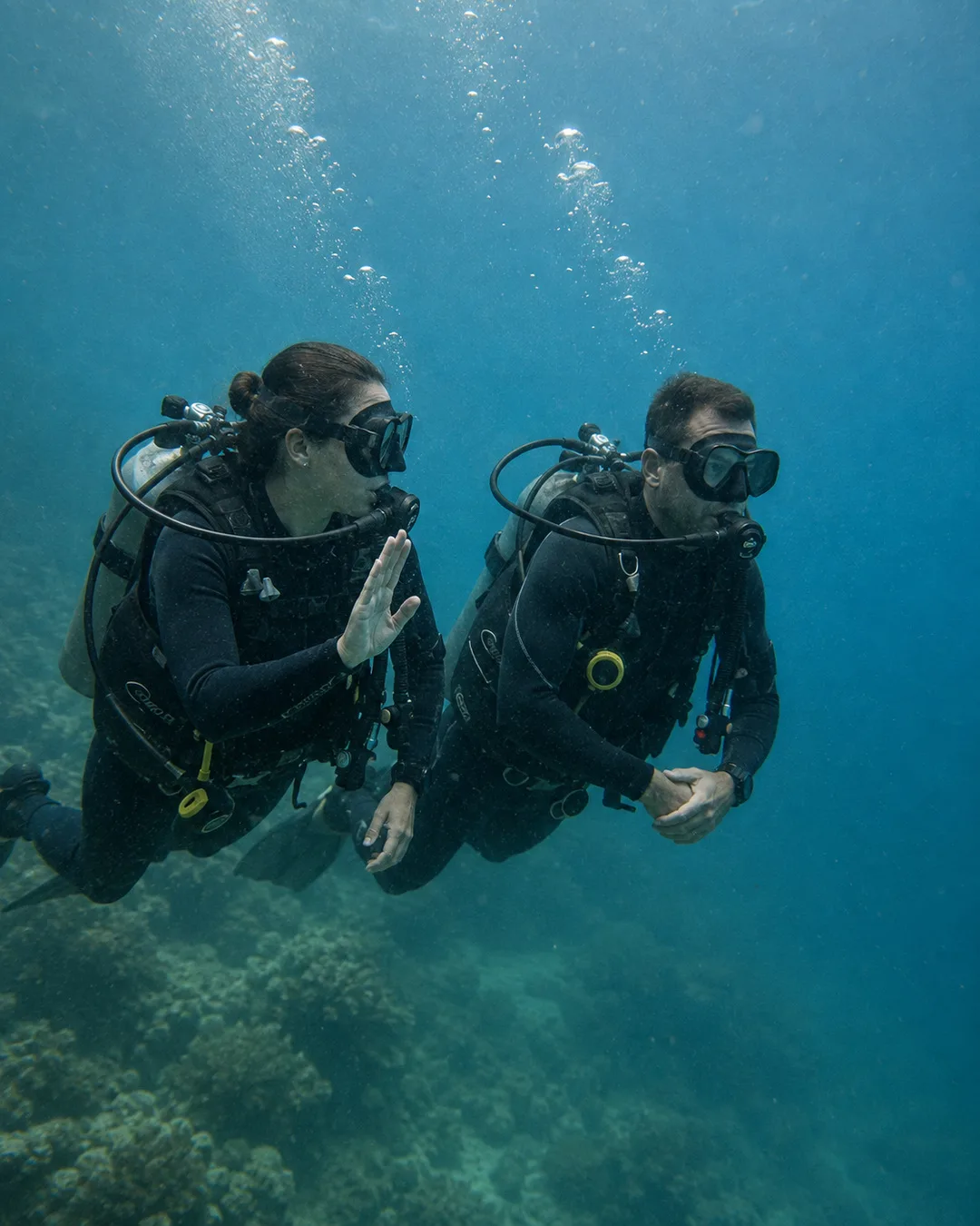 Two divers maintaining buddy awareness underwater